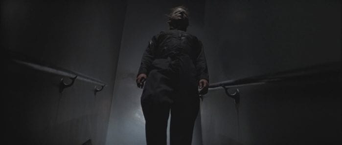michael myers stands on the stairs