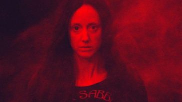 Mandy bathed in red light and smoke