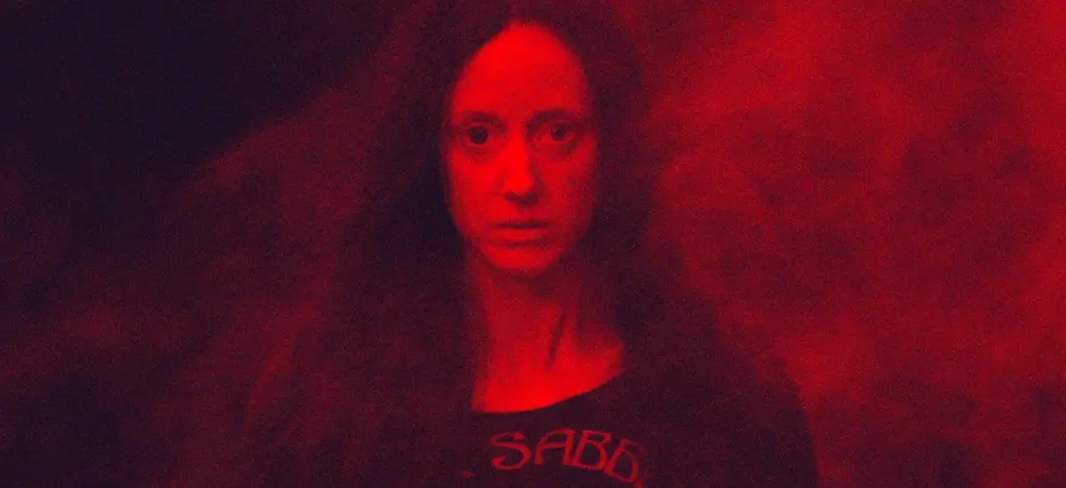 Mandy bathed in red light and smoke