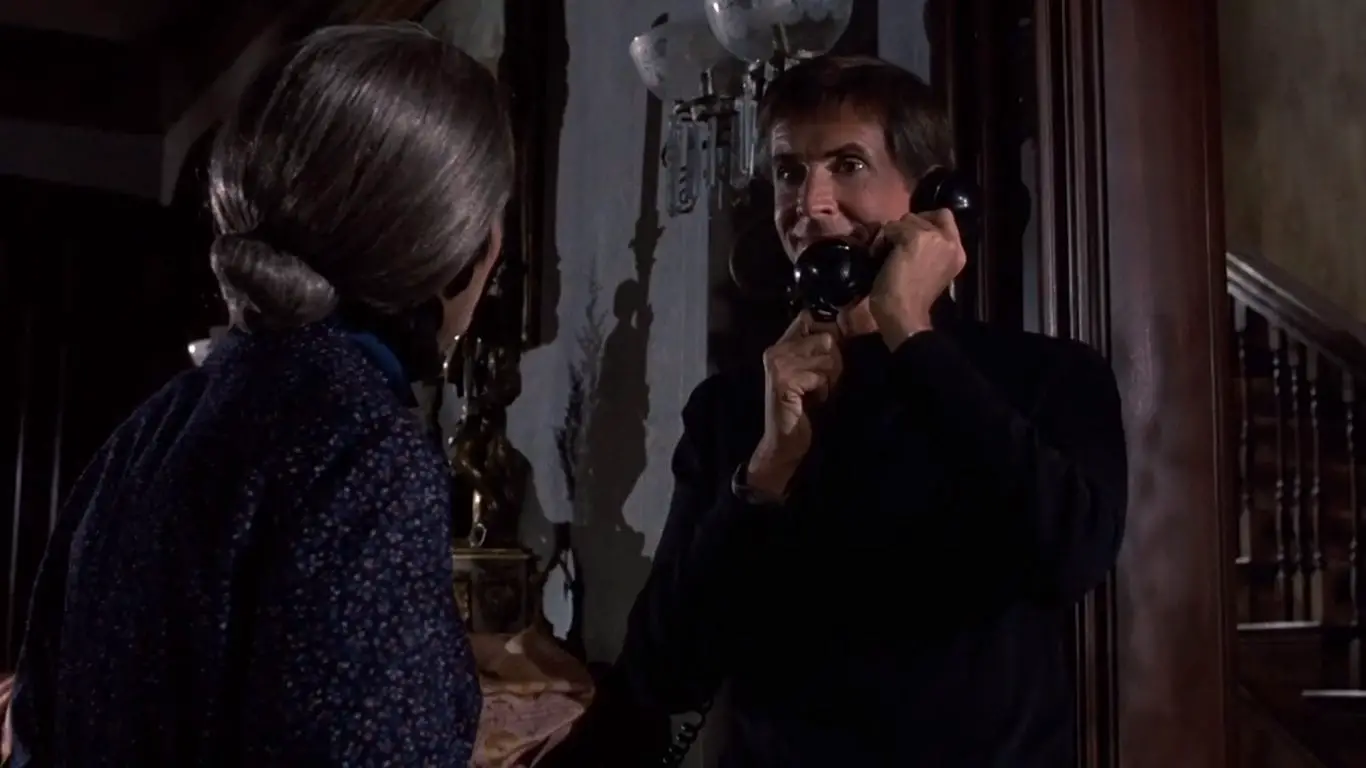 Norman Bates talks on the phone with a smile