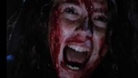 a woman screaming covered in blood