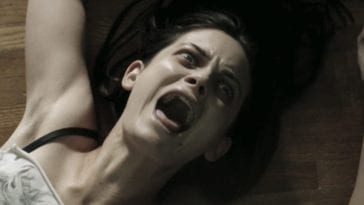 a woman screams as she's dragged across the floor