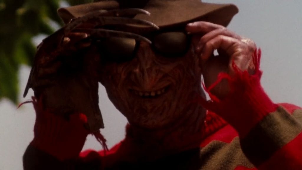 Freddy Krueger puts on sunglasses at a day on the beach in Dreamland.