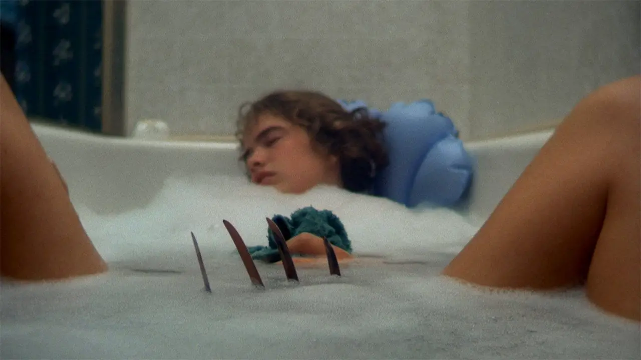 Nancy (Heather Langenkamp) makes the fatal mistake of falling asleep in the bath with Krueger on the loose in her dreams.