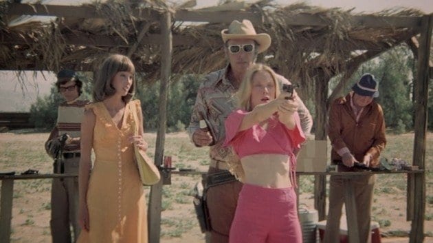 Pinky (Sissy Spacke) shooting guns with Edgar (Robert Fortier) as MIllie (Shelley Duvall) stares in disbelief that this is the same Pinky. 