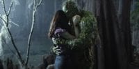 Swamp Thing (Derek Mears) and Dr. Abby Arcane in a tender embracde.