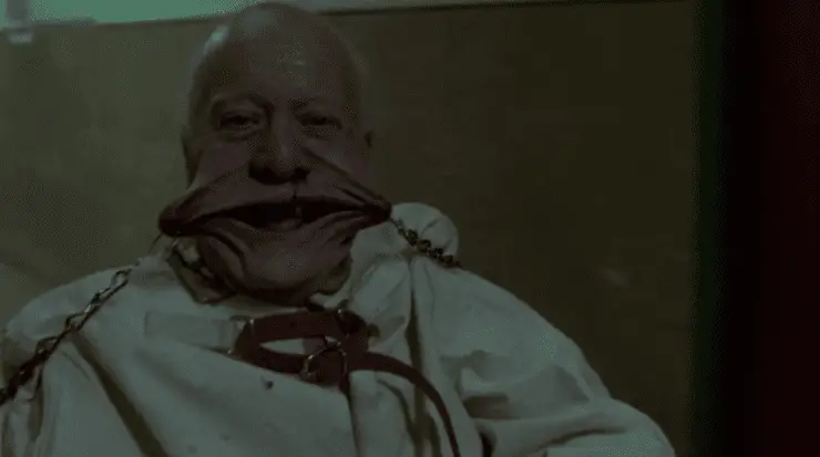 An old man is forced into a smile and laughs like a child in a memorable scene in Hellraiser: Inferno.