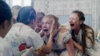 Dani screams while surrounded by the females of the cult in Midsommar