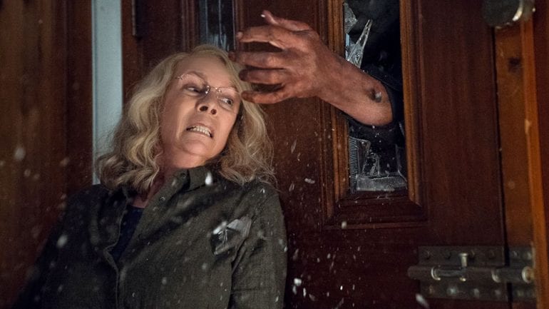 Laurie Strode (Jamie Lee Curtis) protects herself from Michael Myers in Halloween 2018