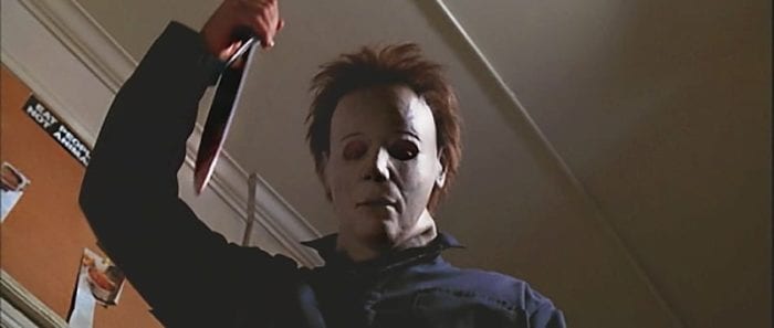 Michael Myers raises his knife before plunging it into his victim