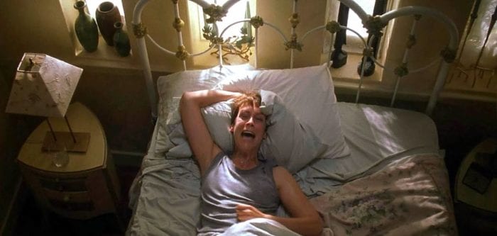 Laurie Strode screams herself awake in bed after having another nightmare about Michael Myers