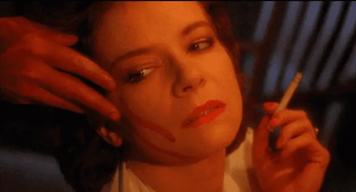A hand wipes blood on Julia's face in Hellraiser