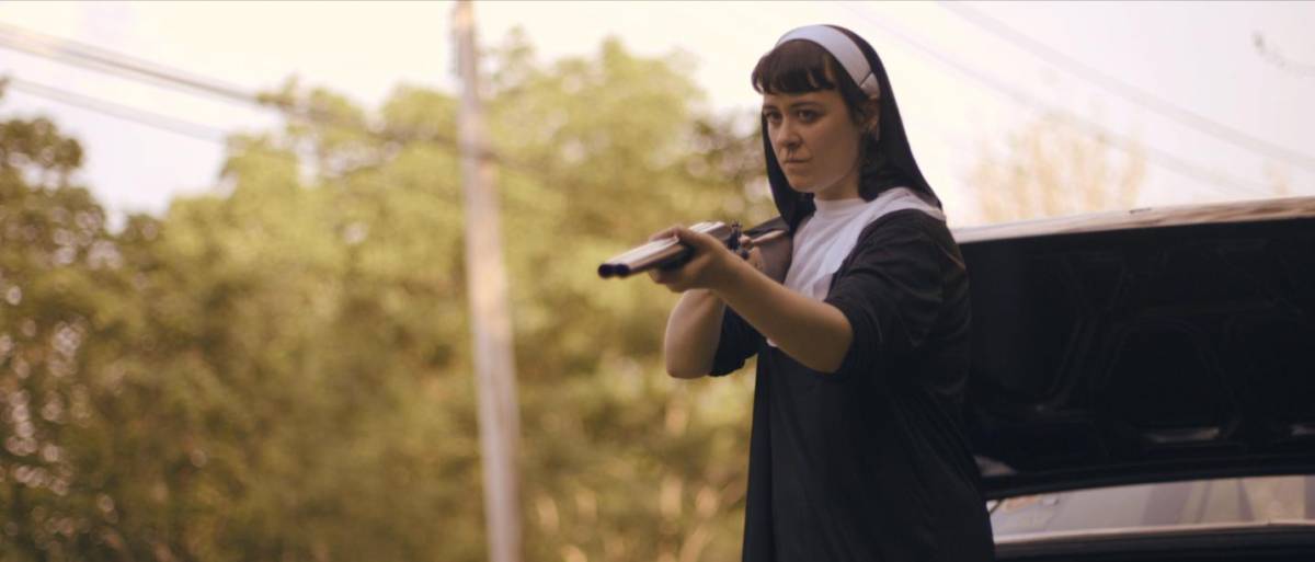 Hoffman as Amanda with a gun in Get My Gun