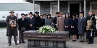 The Nakayama and Furuya families stand around the coffin of Mrs Furuya at her funeral