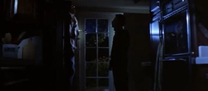 Micheal stares at Bob, who is hanging dead, pinned to the door with a large kitchen knife.