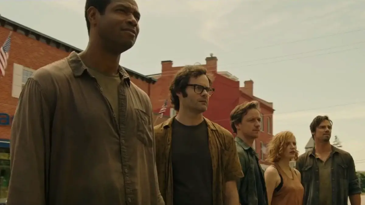 The five now grown up kids from IT Chapter one stand on a street.