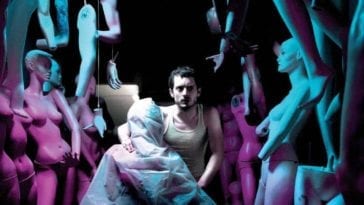 Frank (Elijah Wood) sits amongst his mannequins in a dramatically lit promo shot