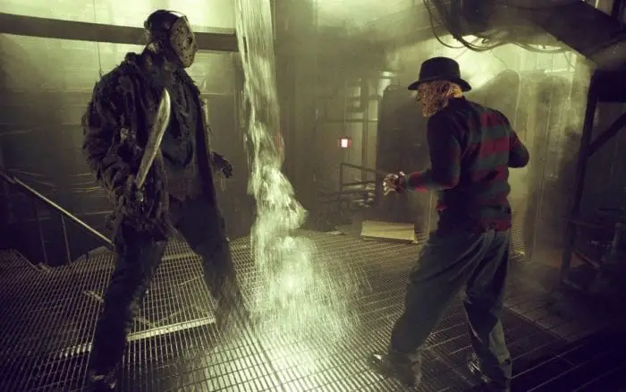 Jason vs Freddy fighting in an underground building with water pouring 