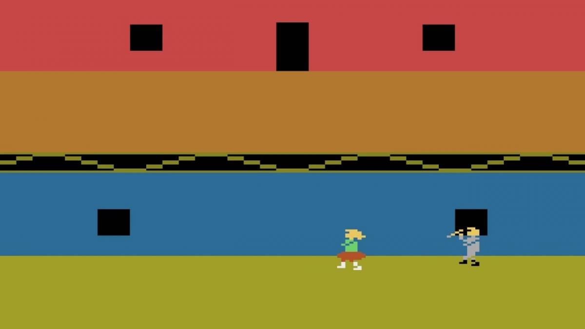 An 8 bit screen shows a killer chasing a babysitter in dated graphics
