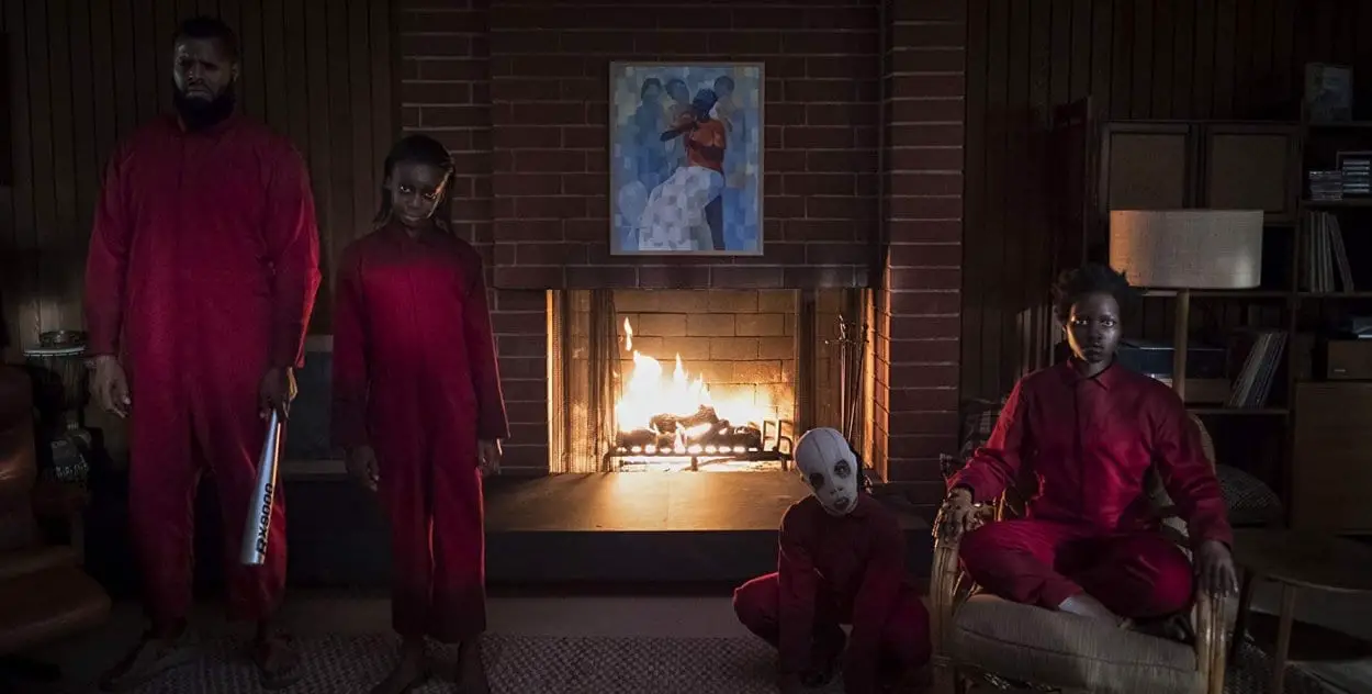 A family of a father, daughter, boy and mother stand menacingly in front of a fire place