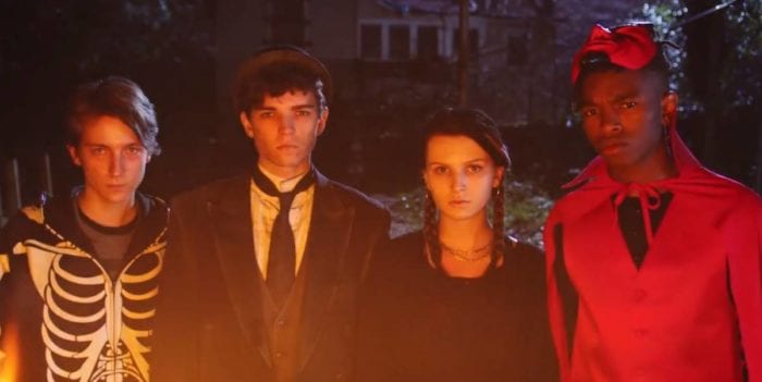 Four teenagers in Halloween costumes.