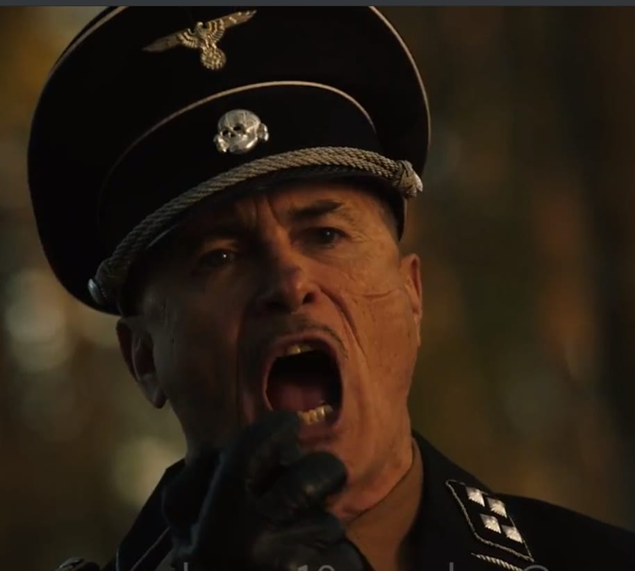 A Nazi yells into a microphone.