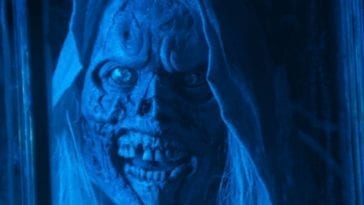 A close-up of The Creep's ghoulish, corpse like face as he looks into a window.