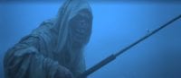 The shrouded and corpse-like Creep holds a fishing pole before a foggy background