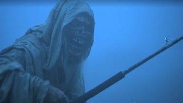 The shrouded and corpse-like Creep holds a fishing pole before a foggy background