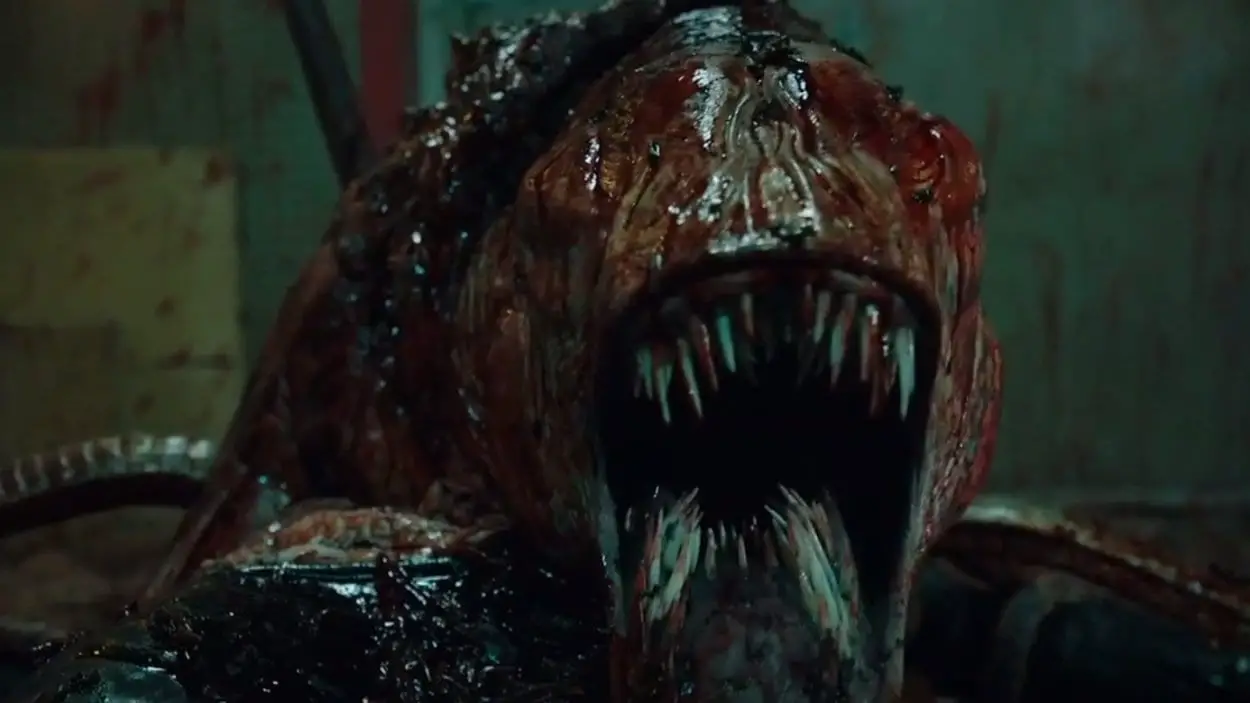 Close up shot of a bloody and grotesque monster with tentacles and rows of sharp teeth