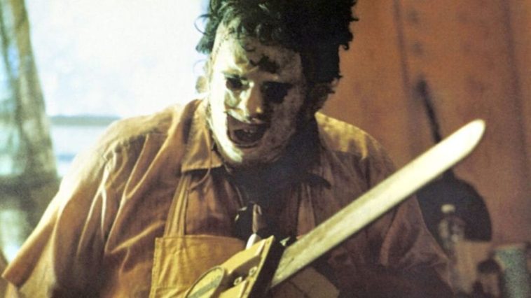 Leatherface, chainsaw in hand, getting down to work.