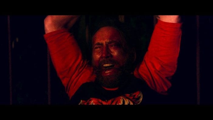 Nic Cage's character in Mandy watches in horror as the titular Mandy is killed. He is gagged and tied at the wrists.