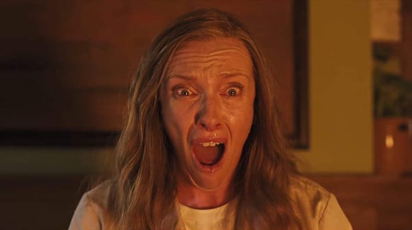 Toni Collette's character stares at something burning off screen wearing a face of pure terror