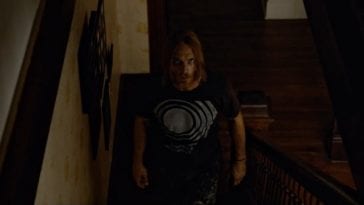 Ethan Embry's character in the Devil's Candy walks slowly up some stairs