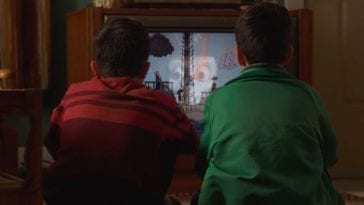 Twin boys watch Candle Cove on an old television set.