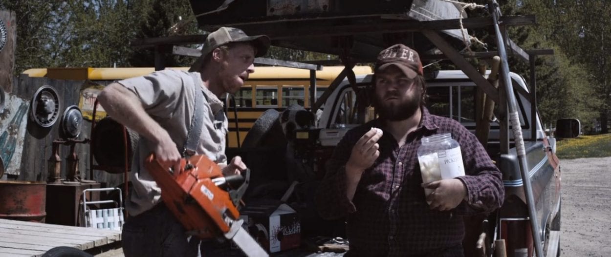 Tucker and Dale chat in a parking lot
