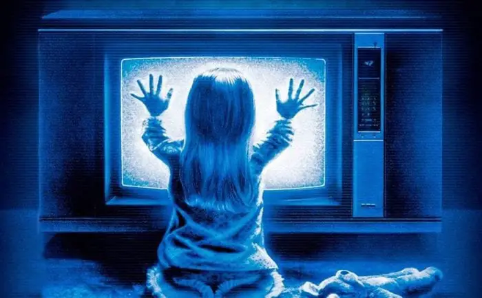 Heather O'Rourke sitting in front of static tv in Poltergeist