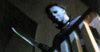 Michael Myers looking down while wielding a knife.