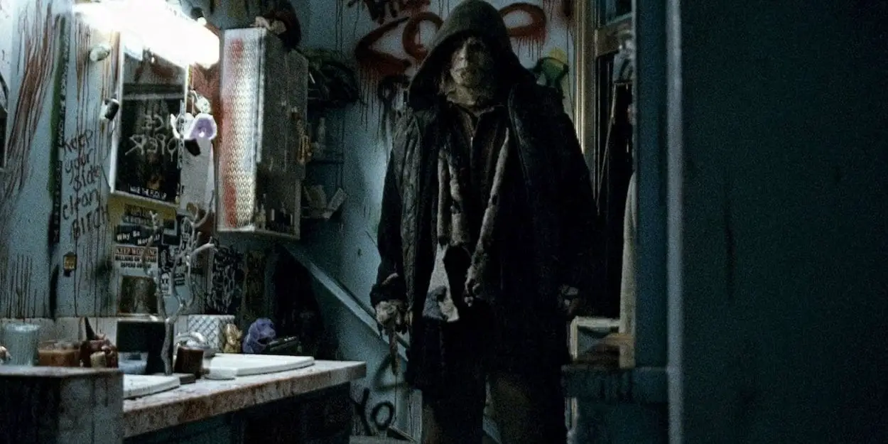 Michael Myers stands in a bloodied bathroom.