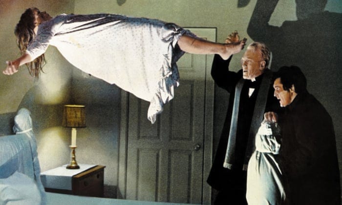 A priest tries to exorcise a demon from a levitating young girl