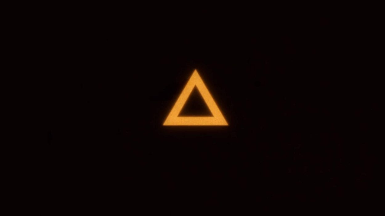 Yellowish-orange triangle floating in the middle of a black field
