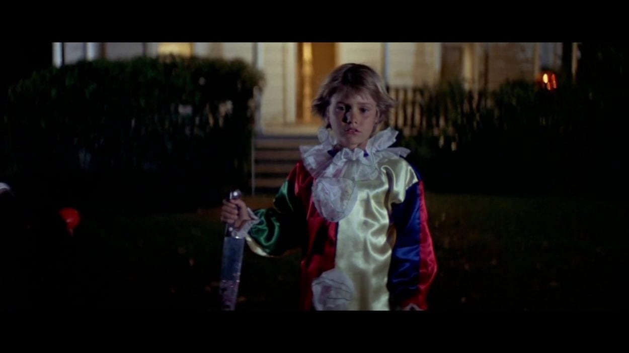 Young Michael Myers in clown costume.