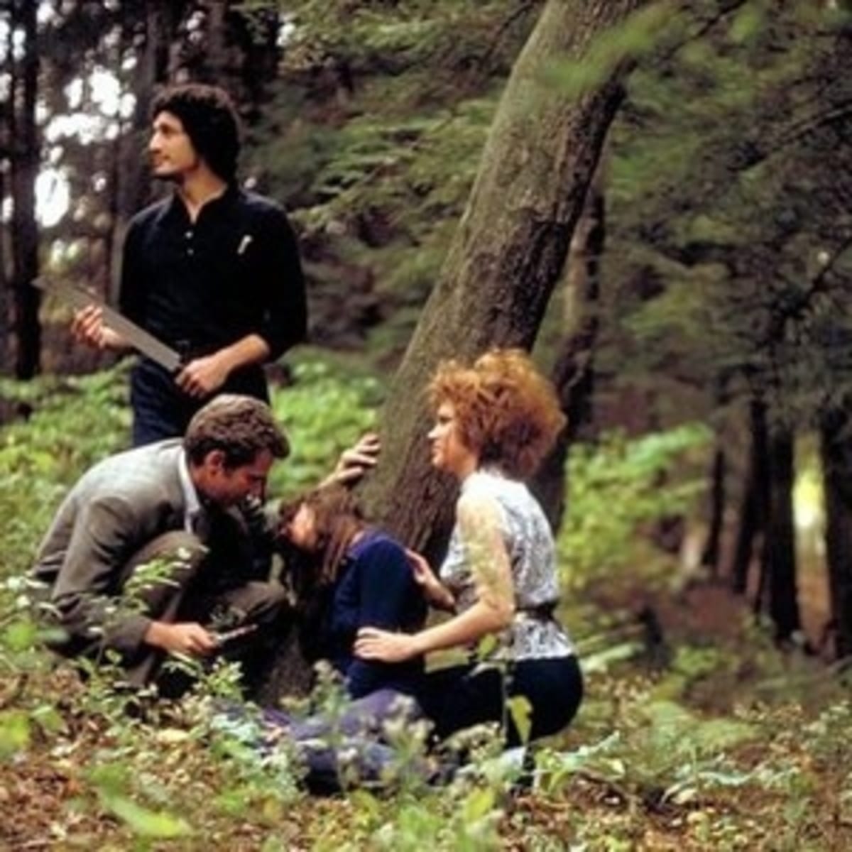 Weasel holds a knife to Phyllis in the woods