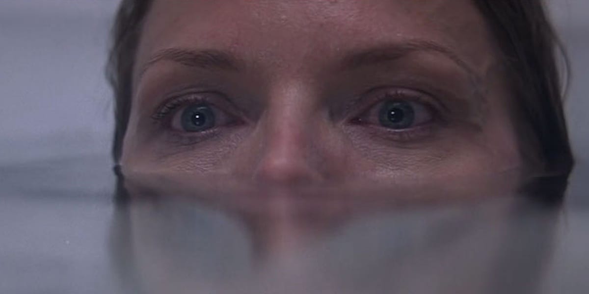 Claire in the bathtub in What Lies Beneath, eyes and nose barely above water, looking ahead in fear