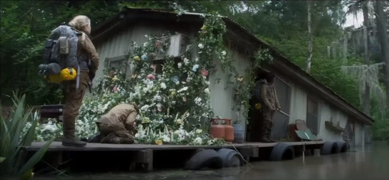 A half sunken shack from Annihilation. Beautiful flowers climb the side not yet submerged in swamp.