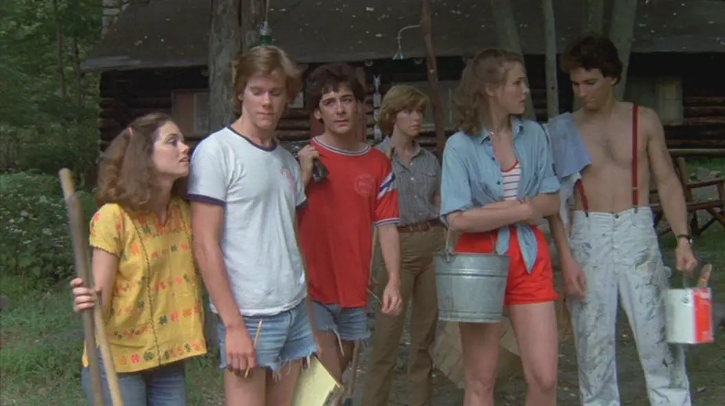 The Camp Crystal Lake counselors stand about, seemingly bored.