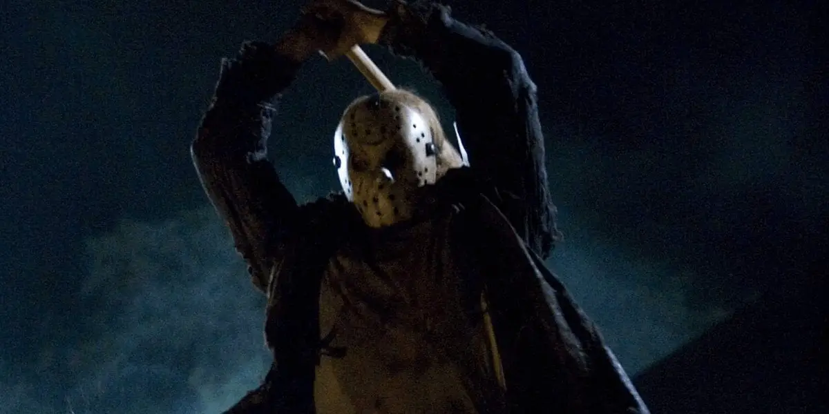 Jason wields a hatchet in the air, preparing to plunge it into his victim.