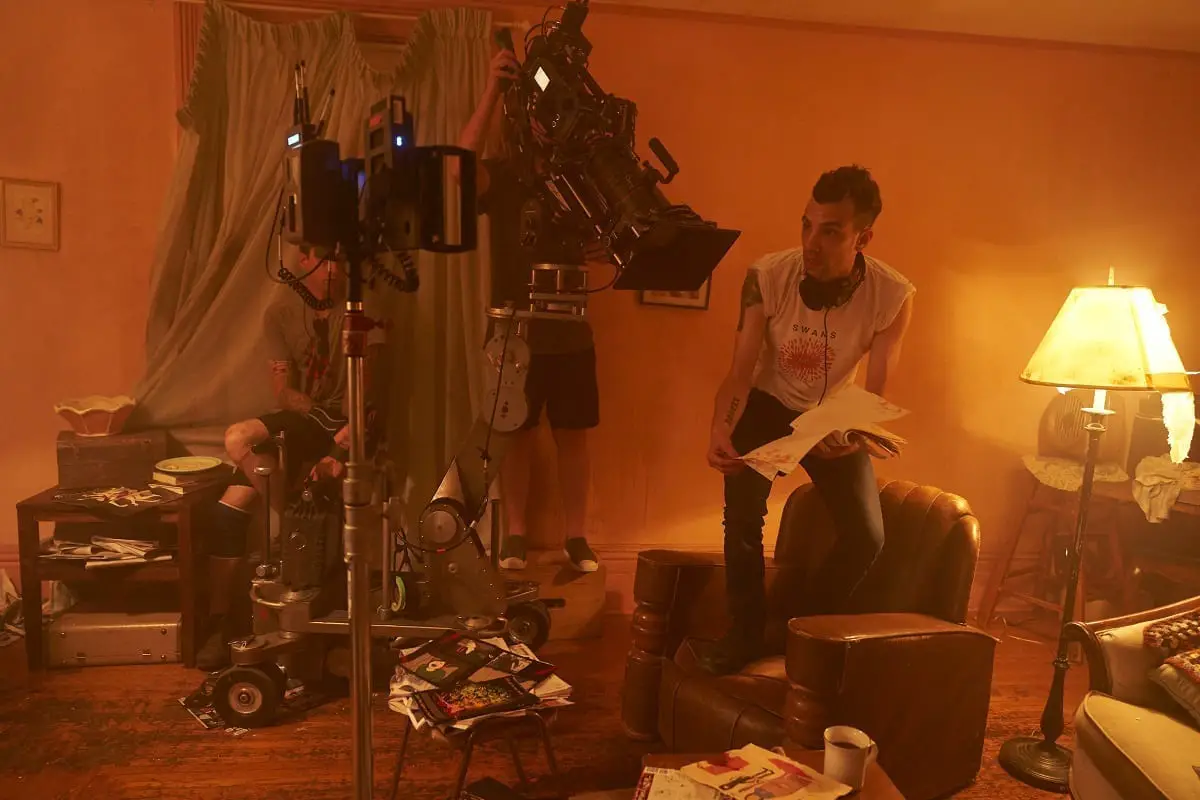 Jay Baruchel stands on a chair giving direction.