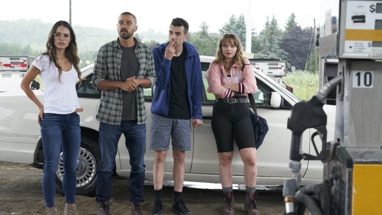 Kathy, Todd, Ezra, and Aurora stand at a gas station wondering what to do.