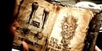 close up of an open book with yellowed pages depicting sketches of a ghoulish skull, disembodied eyeballs, and foreign script.